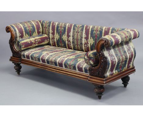 A mid-Victorian mahogany sofa with foliate carved scroll arms, padded back &amp; sprung seat upholstered striped floral damas