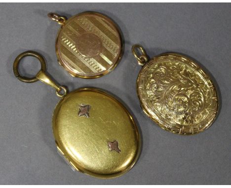 A 9ct. gold circular engine-turned pendant locket; &amp; two un-marked yellow metal oval pendant lockets.
