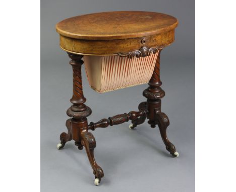 A Victorian burr-walnut oval work table with hinged top enclosing satinwood interior fitted with numerous compartments, with 