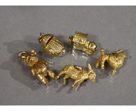 Five 9ct. gold pendant bracelet charms: Teddy bear; Donkey; Poodle; Baby in a wicker crib; &amp; ‘The Old Woman Who Lived In 