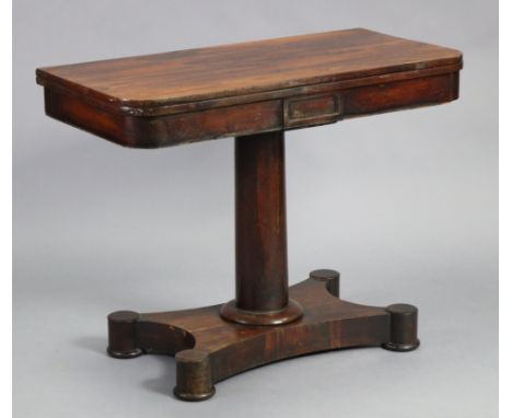 An early Victorian rosewood card table, with rounded corners to the rectangular fold-over top, inset red baize, on a gun-barr