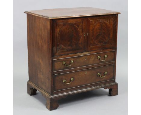 A mahogany small rectangular chest commode, with moulded edge to the hinged lift-top, faux panel doors &amp; a mock drawer to