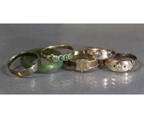 A 9ct. gold ring set tiny garnets &amp; seed pearls; another set three small white stones; an un-marked yellow metal ring set