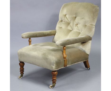 A Victorian walnut easy chair with shaped buttoned back, open arms, &amp; sprung seat upholstered pale green velour, on balus