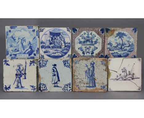 An 18th century English tin glazed tile decorated with a hunting scene within a powdered manganese border; a similar tile dec