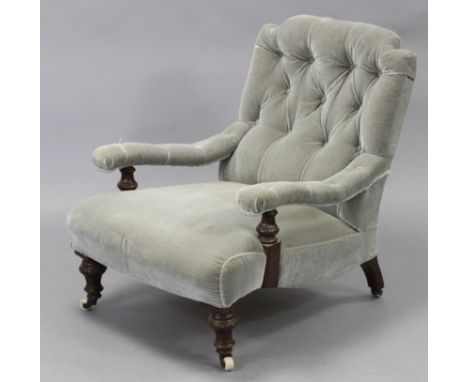 A Victorian mahogany frame armchair, with buttoned back &amp; arms &amp; padded seat upholstered light blue velour, on carved