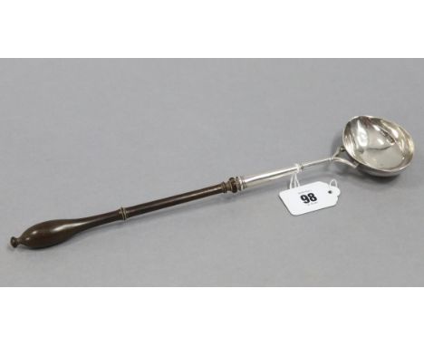 A George II punch ladle with oval bowl &amp; turned wood handle, 13¼” long; London 1750, by William Justus.