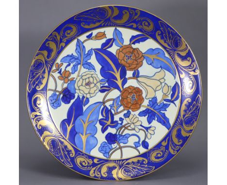 A Bursley Ware pottery charger designed by Charlotte Rhead, pattern No. 1420, decorated with flowers &amp; foliage on a white
