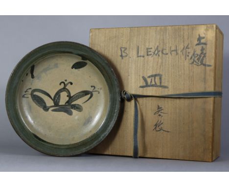 BERNARD LEACH (1887-1979).  A large stoneware shallow dish with raised border, the centre painted with a stylised floral moti
