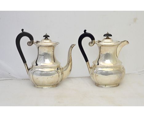 A silver coffee pot, with a matching silver hot water jug, each piece of curved baluster form, with a shaped lower part to th