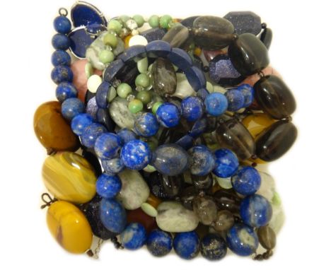 A single row necklace of lapis lazuli beads, a lapis lazuli bracelet, a pair of reconstituted lapis lazuli earrings, a gradua