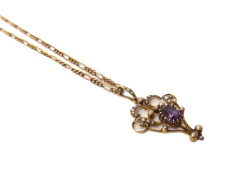 An Edwardian gold, amethyst and seed pearl set pendant, in a scroll pierced openwork design, claw set with the oval cut ameth