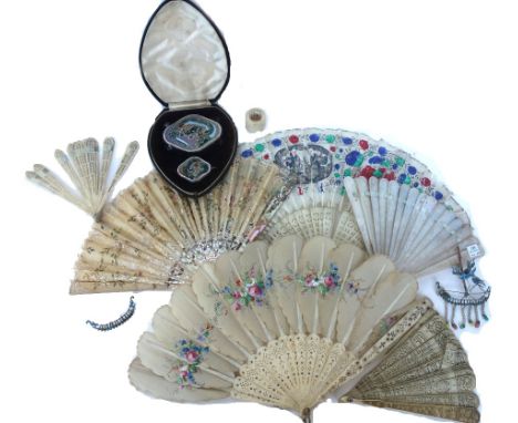 A Cantonese mother-of-pearl fan, late 19th century, engraved all over with Oriental scenes, 18cm long, a Chinese painted feat