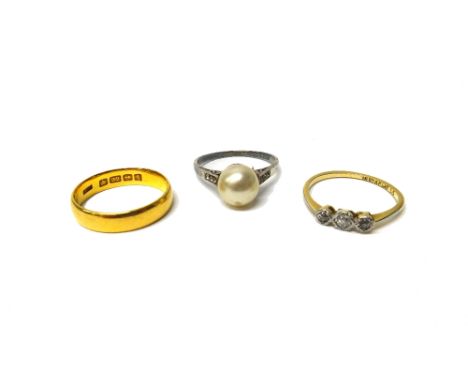 A 22ct gold plain wedding ring, Birmingham 1910, weight 4.2 gms, a gold and diamond set three stone ring, mounted with a row 