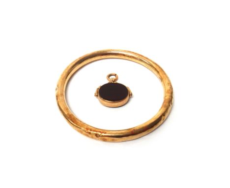 A gold circular bangle, detailed 9 C (dented), gross weight 17.5 gms and a 9ct gold mounted bloodstone and cornelian rotating