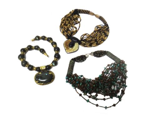 A labradorite bead necklace, the front with an oval labradorite pendant, by Eileen Coyne, a carved jade and ceramic multiple 