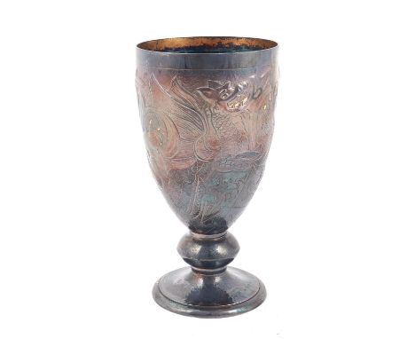 A silver goblet, decorated with royal emblems, including a lion, a dragon and a unicorn, with gilt highlights, raised on a ma