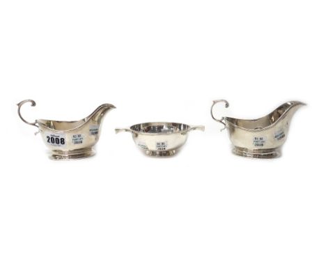 Silver, comprising; a pair of sauceboats, each with a scrolling handle, Birmingham 1932 and a Scottish twin handled quaich, E