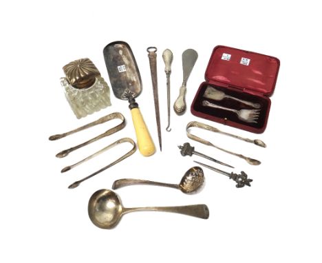 Silver and silver mounted wares, comprising; three pairs of sugar tongs, a sugar sifting spoon, a skewer with a ring and scal