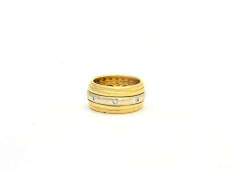A gold and diamond ring by Wempe, formed as four yellow gold bands, centralised with an articulating white gold band set with