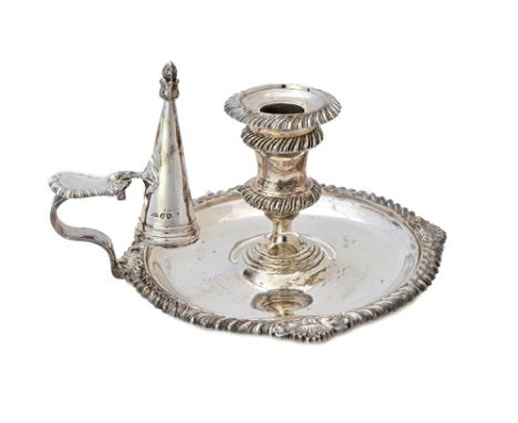 A late Victorian silver chamber candlestick, of shaped circular form, decorated with gadrooned rims and with a snuffing cone 