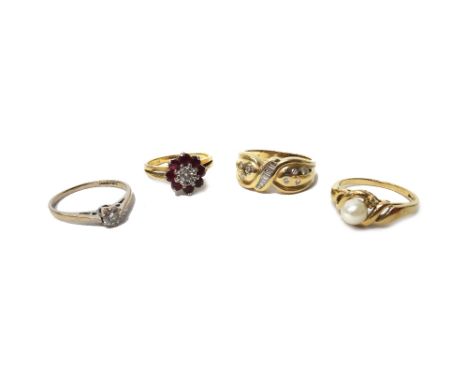 An 18ct gold, ruby and diamond nine stone cluster ring, mounted with the circular cut diamond at the centre, in a surround of