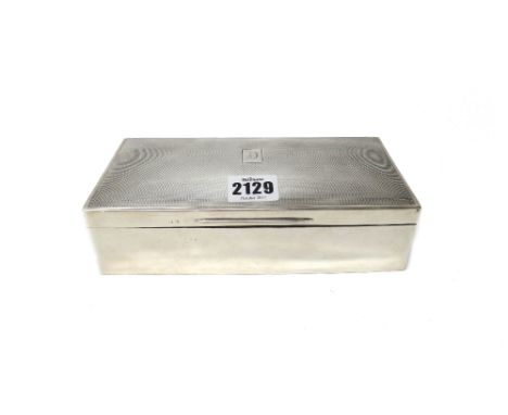 A silver rectangular large table cigarette box, wooden lined within, the hinged lid engine turned, Birmingham 1925.