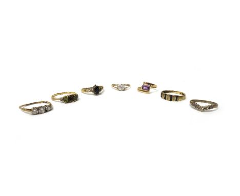 A 9ct gold ring, mounted with a rectangular cut amethyst, in a crossover design, a 9ct gold, sapphire and diamond set ring an