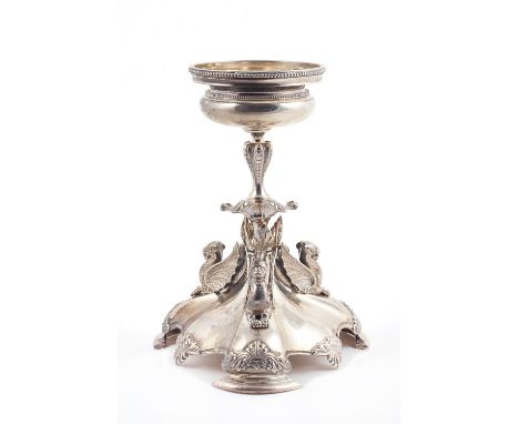 A Victorian silver table centrepiece stand, of triform with three dragon supports, raised on a shaped base, with cast palmett