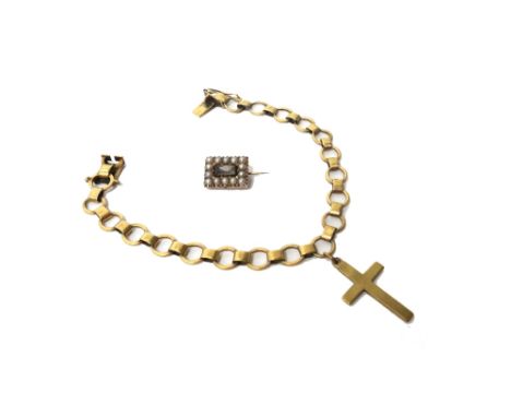 A gold bracelet in a circular and oval link design, on a snap clasp, fitted with a 9ct gold plain pendant cross and a gold an
