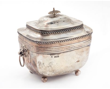 A large late Victorian silver tea caddy, of rounded rectangular form, with a domed hinged lid and twin lion masked ring handl