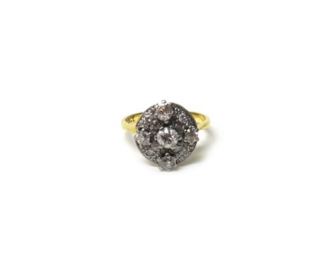 A gold and diamond set cluster ring, mounted with the principal cushion shaped diamond at the centre, in a surround of four l