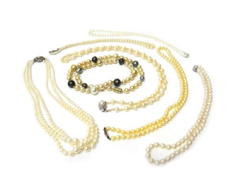 A three row necklace of graduated cultured pearls on a colourless paste and imitation pearl clasp and six further single row 