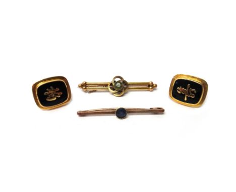 A pair of gold mounted, black onyx cufflinks, the fronts with Oriental character motifs and with folding bar fittings at the 