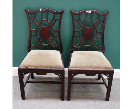 A pair of Chinese Chippendale style mahogany framed side chairs, with cockpen backs on block supports, 52cm wide x 98cm high 