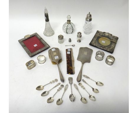 Silver and silver mounted wares, comprising; two photograph frames, a faceted glass sugar caster, two scent bottles, a smelli