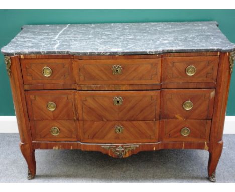 A 19th century French gilt metal mounted kingwood commode, the shaped marble top over three long drawers, on cabriole support