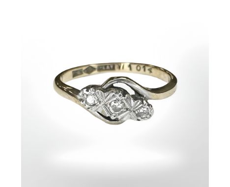 An 18ct gold and platinum three stone diamond twist ring, size K½ CONDITION REPORT: 1.8g