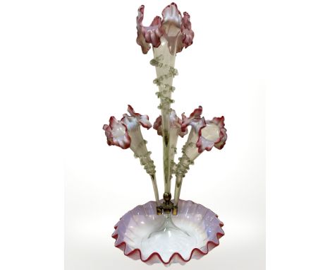 A Victorian glass epergne with four flower holders in clear glass fading into vaseline, with red tinged edges, height 53 cm.