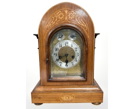 A late Victorian walnut and satinwood inlaid eight day chiming bracket clock with German Junghans movement, striking on a gon