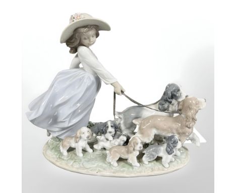 A Lladro figure group of a girl walking dogs, No. 6784.