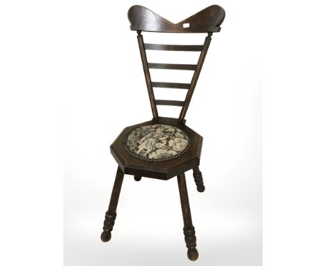 An oak ladder back chair on splayed legs with tapestry seat, height 78 cm.