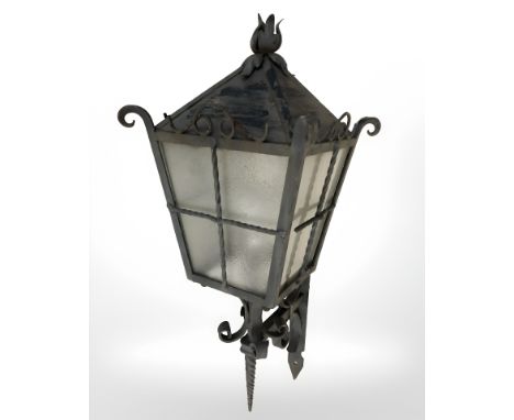 A wrought metal outdoor lantern with bracket, height 70 cm.