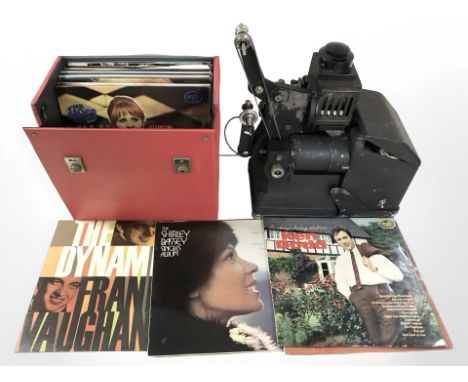 A projector and a case of LP records.