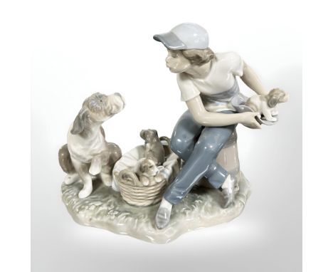 A Lladro figure group of a boy and dogs, No. 5376, height 18 cm.