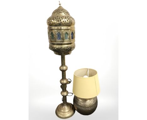 An Islamic brass lantern wired for electricity with stained glass panels and a further bulbous table lamp, tallest 115 cm.