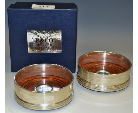 A pair of W I Broadway & Co. silver wine coasters engine turned vacant elongated cartouche dated 1995 conforming box