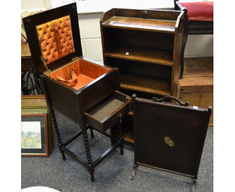 An early 20th century oak sewing box on stand, burnt ochre padded silk interior, drawer to frieze; an early 20th century oak 