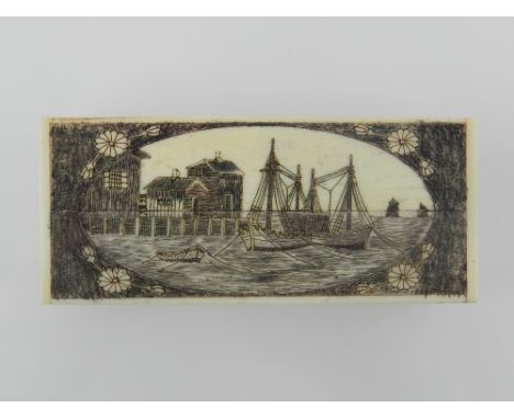 An 18th century style rectangular carved scrimshaw snuff box, the hinged lid decorated with ships in a harbour. 