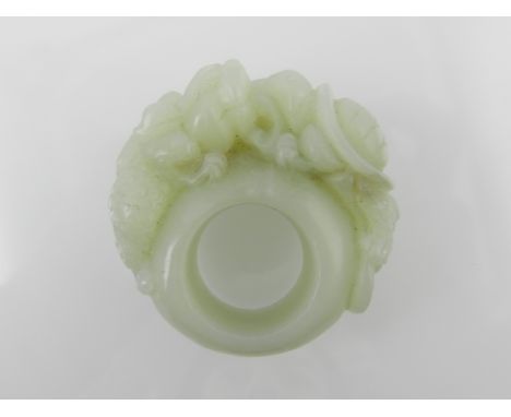 A Chinese jade archers ring, having applied turtle and dragon. 